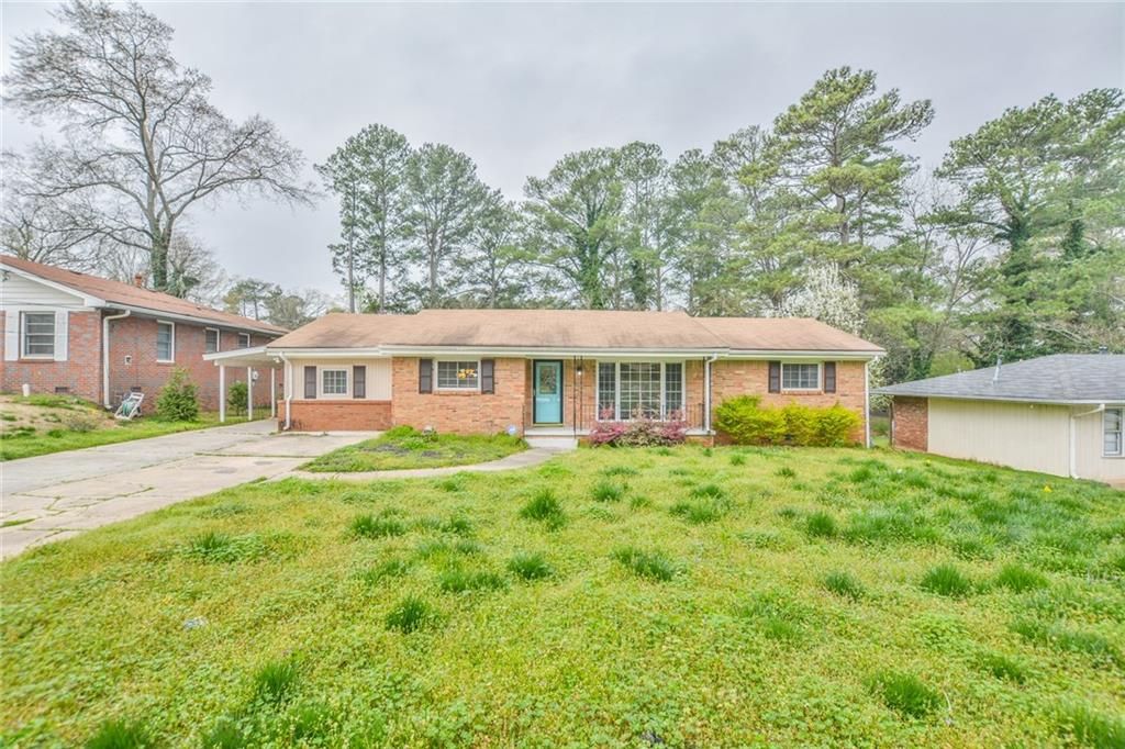2416 Shamrock Drive Decatur, GA 30032 - Photo 1 of 1 a front view of a house with a garden