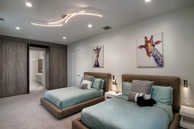 a spacious bedroom with a bed and a large window