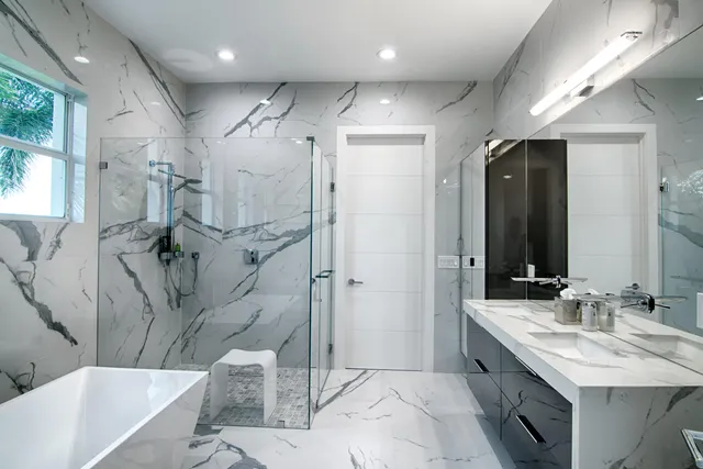 a spacious bedroom with a bed and a flat screen tv