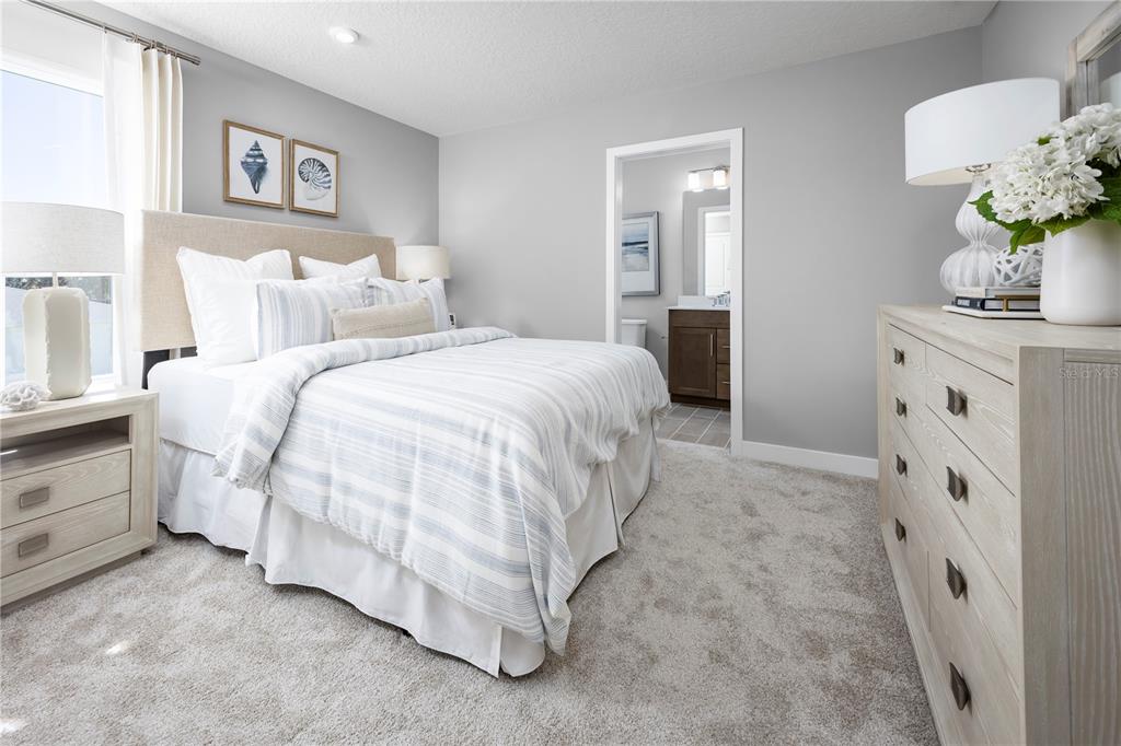 22177 Pine Grove Loop Leesburg, FL 34748 - Photo 12 of 15 a spacious bedroom with a bed and a table