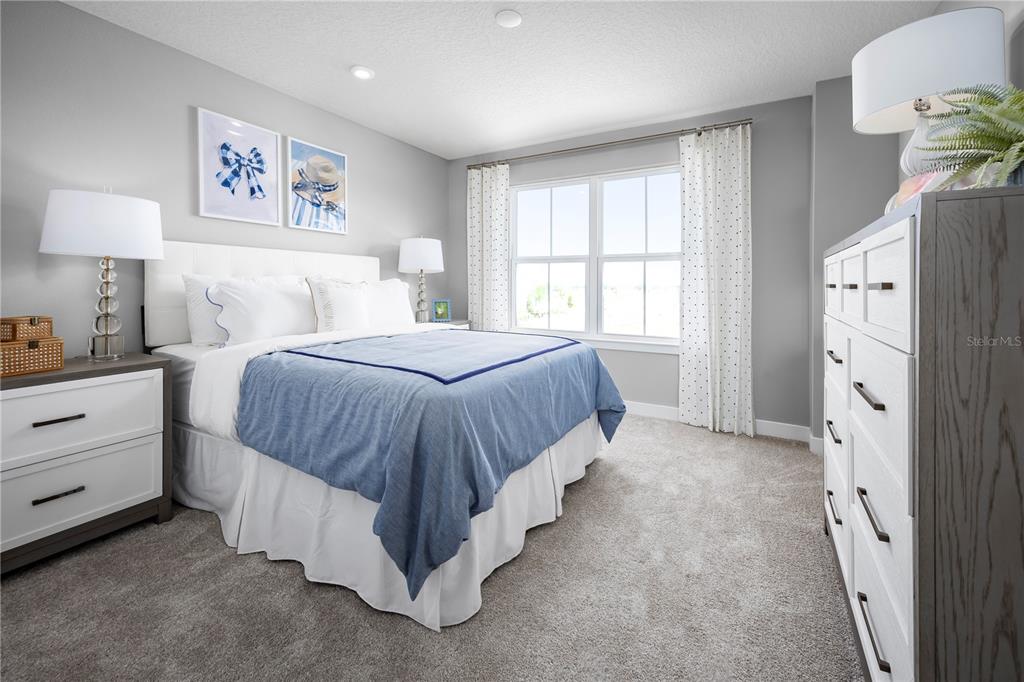 22177 Pine Grove Loop Leesburg, FL 34748 - Photo 13 of 15 a spacious bedroom with a bed and a window