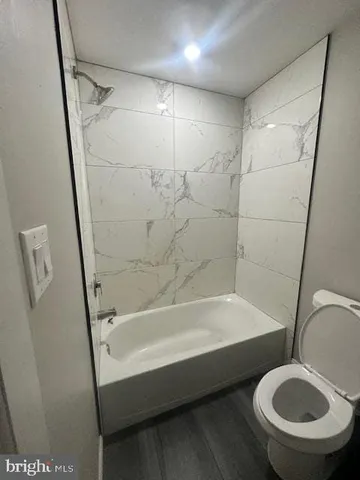 a bathroom with a tub and a shower