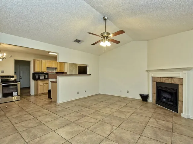 a view of a kitchen with microwave and a stove top oven
