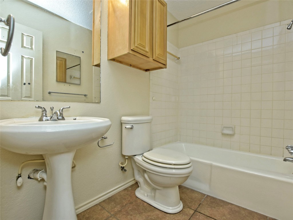 415 Fantail Loop, Unit B Austin, TX 78734 - Photo 4 of 10 a bathroom with a sink toilet and shower