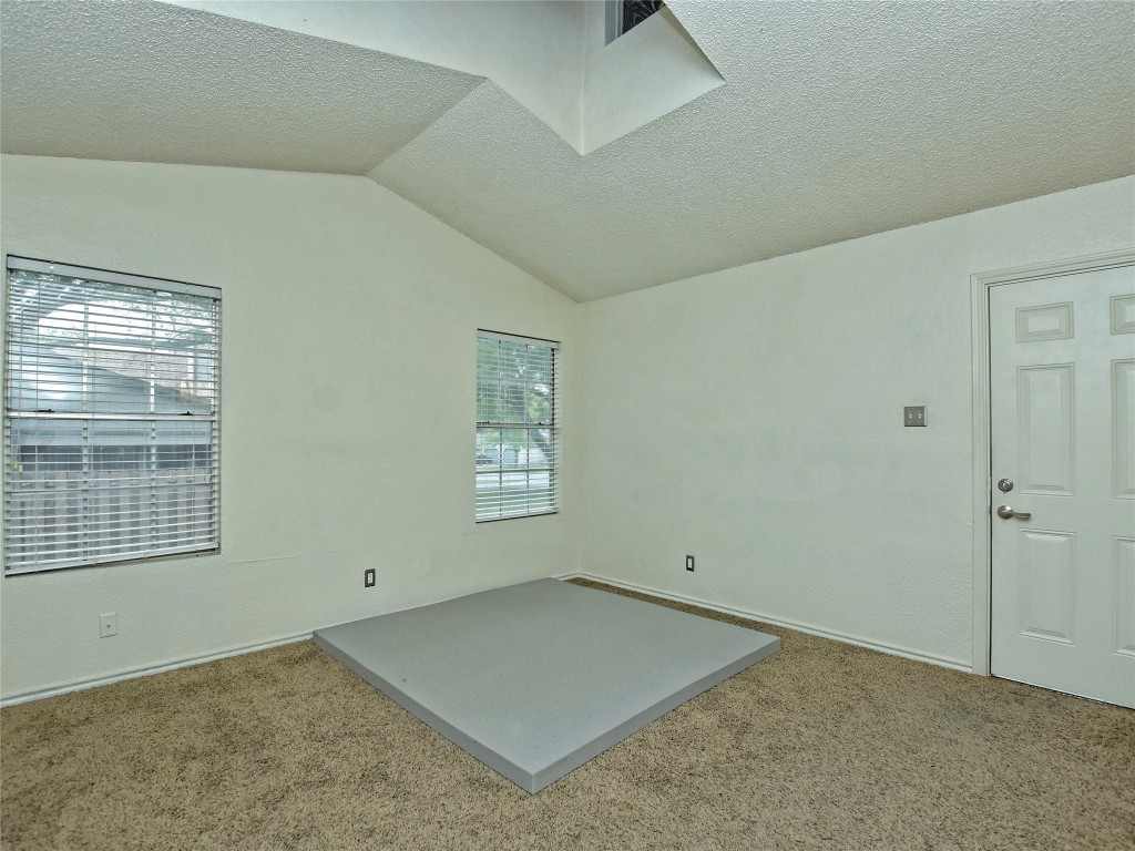 415 Fantail Loop, Unit B Austin, TX 78734 - Photo 5 of 10 an empty room with windows