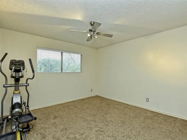 a room with gym equipment and windows