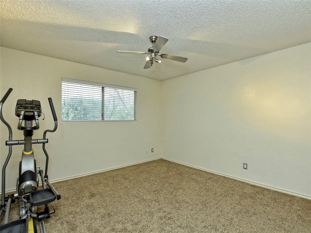 415 Fantail Loop, Unit B Austin, TX 78734 - Photo 6 of 10 a room with gym equipment and windows
