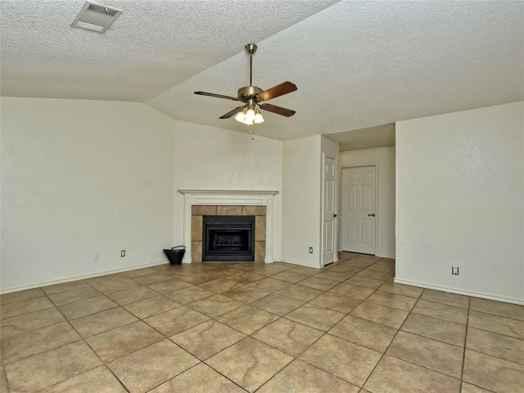 415 Fantail Loop, Unit B Austin, TX 78734 - Photo 8 of 10 a view of an empty room with a ceiling fan and a window