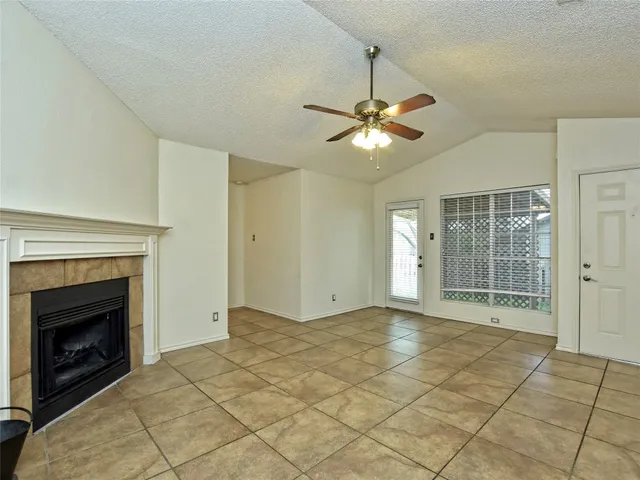 a view of livingroom with fan fireplace and window