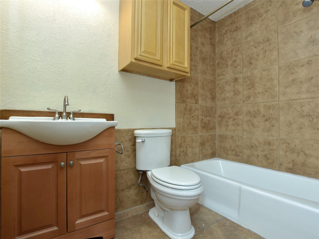 415 Fantail Loop, Unit B Austin, TX 78734 - Photo 10 of 10 a bathroom with a sink a toilet and tub