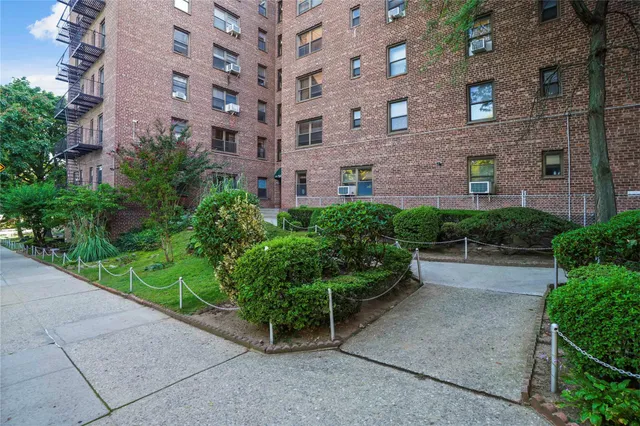 a view of a brick building next to a yard