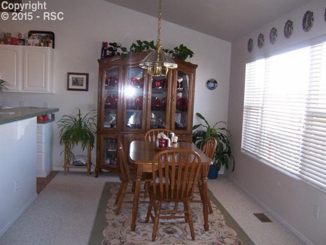 12456 Snaffle Bit Road Peyton, CO 80831 - Photo 4 of 14 Dining Room connected to kitchen