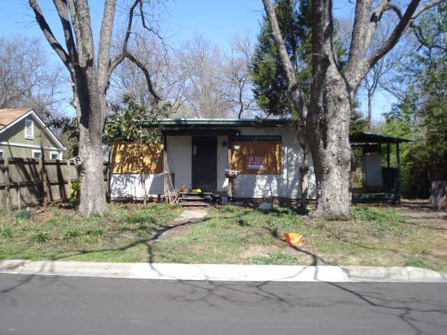 a view of a house with a patio and a yard