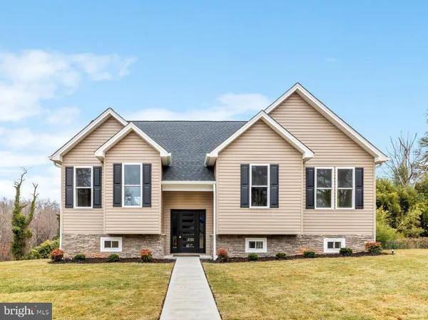 a front view of a house with a yard outdoor seating and garage