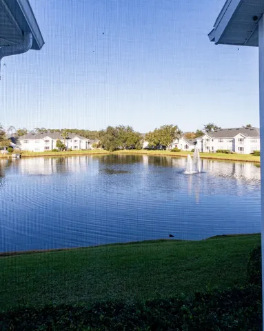 a front view of a house with a garden and a garage