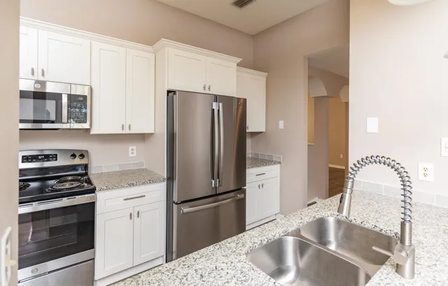a kitchen with a refrigerator sink and stove