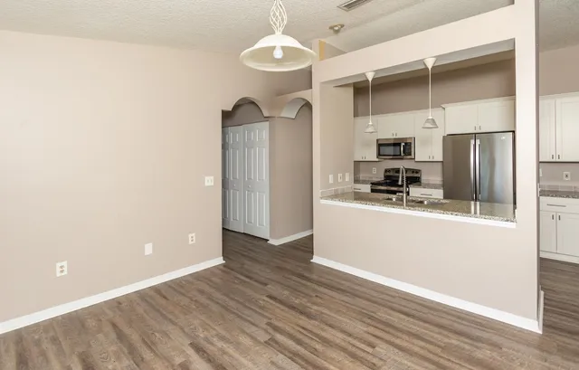 a kitchen with stainless steel appliances a refrigerator and a stove top oven