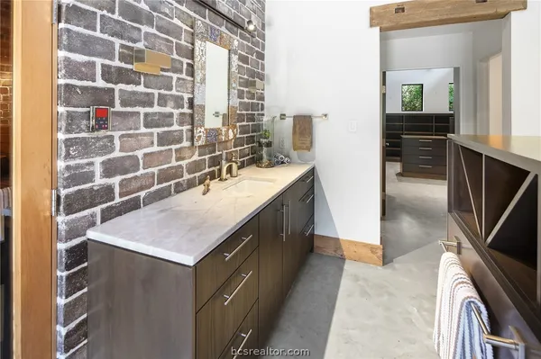 a bathroom with a sink a vanity and a mirror