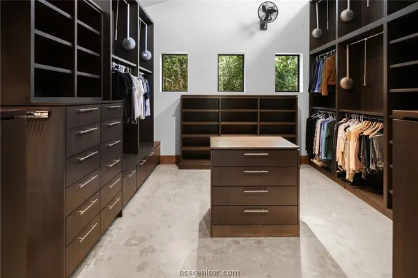 a view of walk in closet and empty room