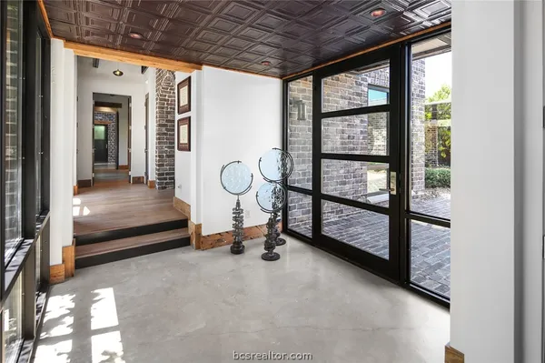 a view of a room with wooden floor and iron stairs