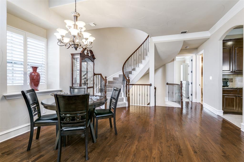800 Rockingham Drive Irving, TX 75063 - Photo 14 of 35 Dining space with dark wood finished floors, a chandelier, stairway, arched walkways, and ornamental molding