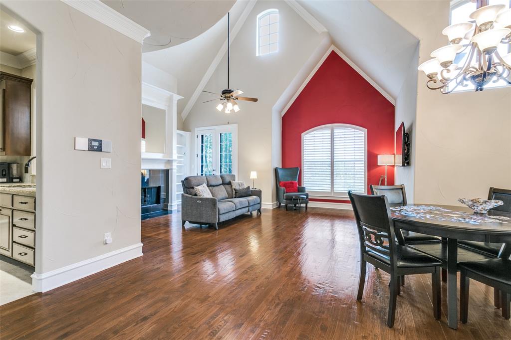 800 Rockingham Drive Irving, TX 75063 - Photo 15 of 35 Dining room with wood floors, high vaulted ceiling, ceiling with a fireplace