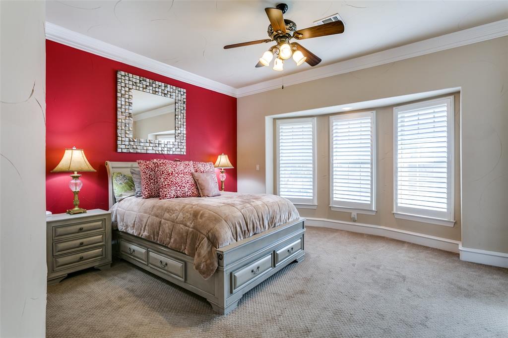 800 Rockingham Drive Irving, TX 75063 - Photo 22 of 35 a spacious bedroom with a bed and a chandelier