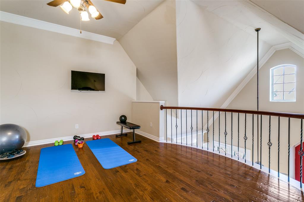 800 Rockingham Drive Irving, TX 75063 - Photo 30 of 35 Loft being used as fitness area with wood floors, and vaulted ceiling