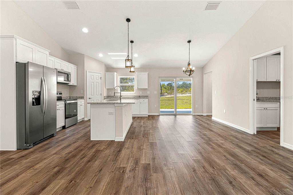 15189 56th Terrace Road Ocala, FL 34473 - Photo 9 of 28 Kitchen and Dining room area. Picture shows slider but actual home has French doors