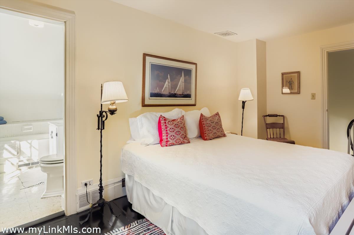 27 Spring Street Vineyard Haven, MA 02568 - Photo 45 of 58 a bedroom with a bed and a painting on the wall