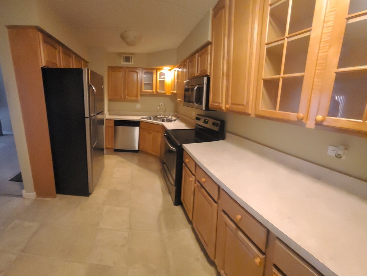 566 Timber Ridge Drive, Unit 203 Carol Stream, IL 60188 - Photo 4 of 17 a kitchen with a sink refrigerator and microwave
