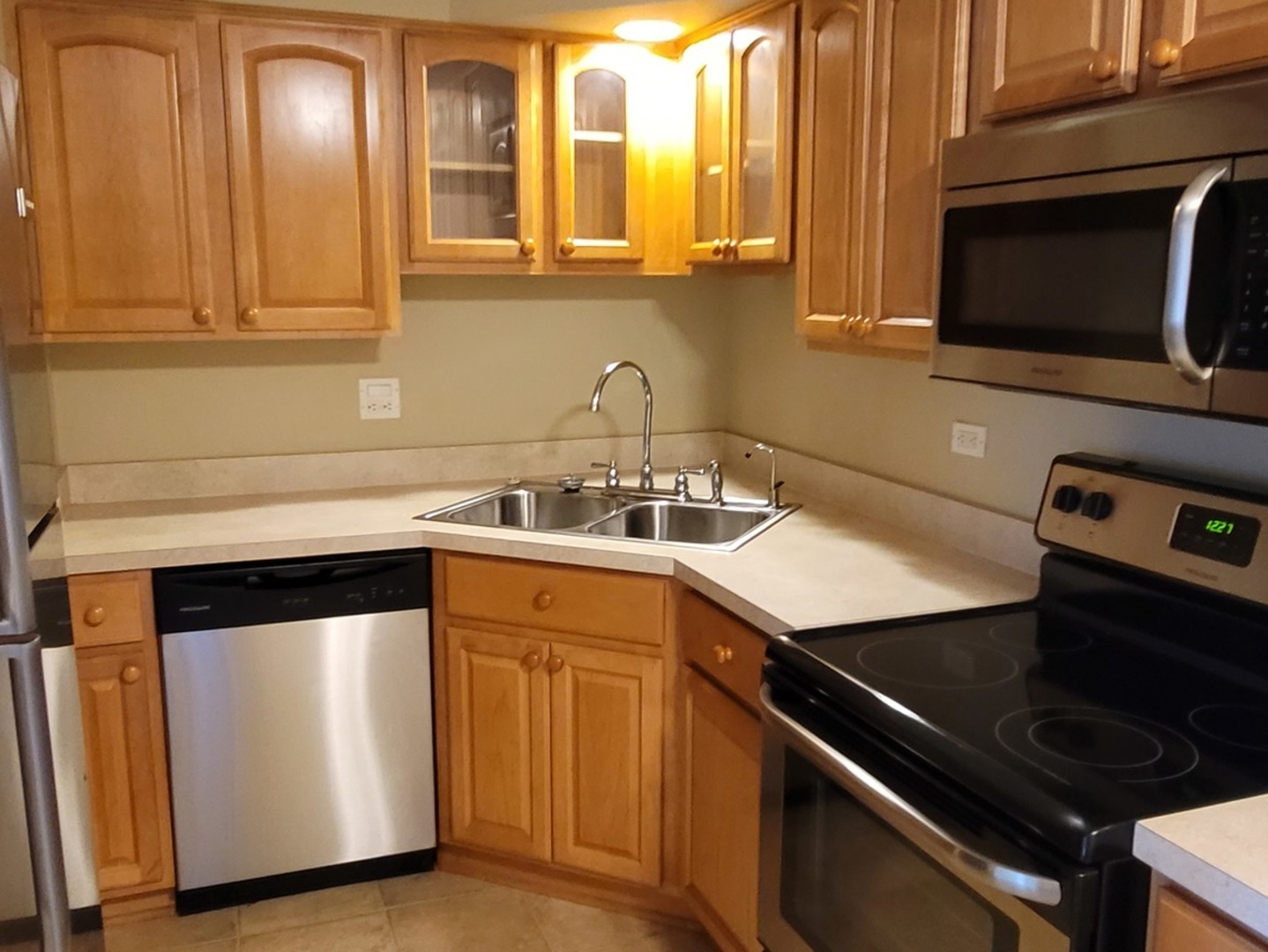566 Timber Ridge Drive, Unit 203 Carol Stream, IL 60188 - Photo 6 of 17 a kitchen with a sink stove and microwave