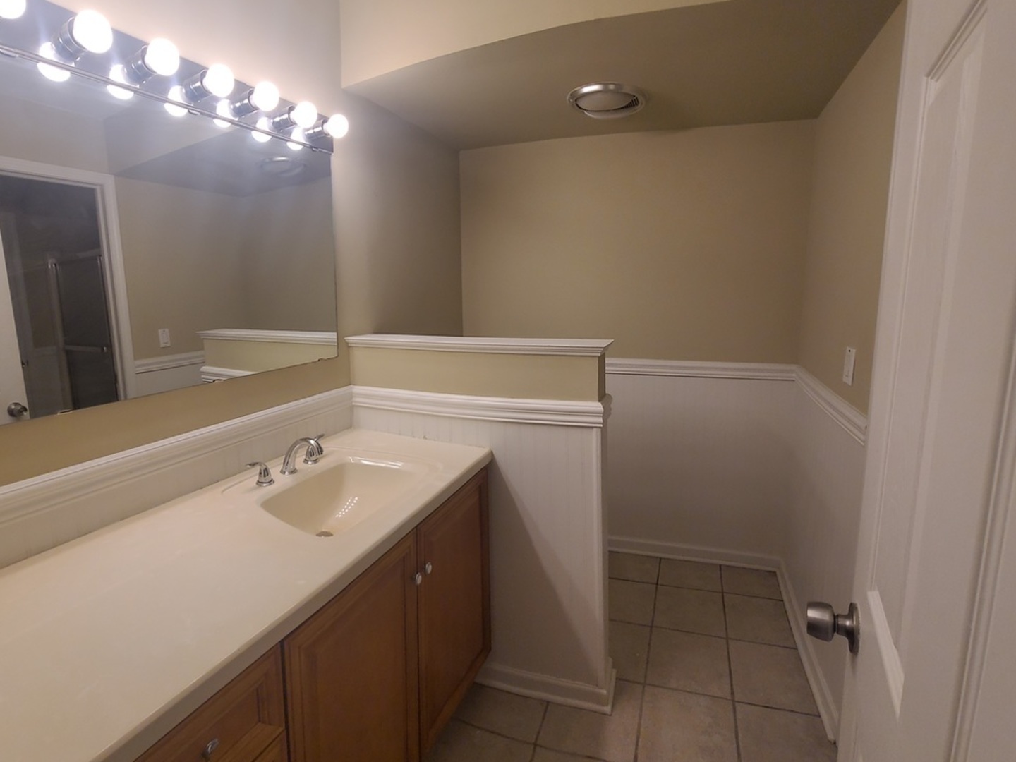 566 Timber Ridge Drive, Unit 203 Carol Stream, IL 60188 - Photo 8 of 17 a bathroom with a sink vanity and a mirror