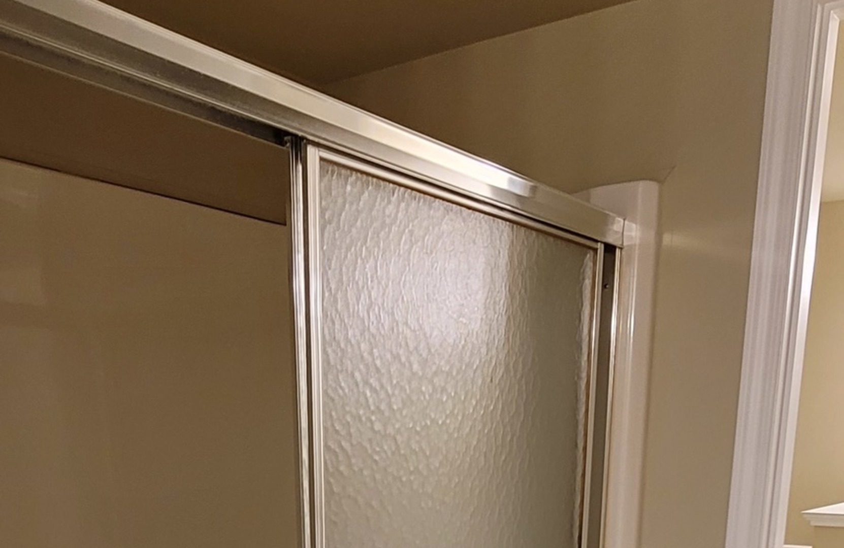 566 Timber Ridge Drive, Unit 203 Carol Stream, IL 60188 - Photo 10 of 17 a bathroom with a shower and a glass door