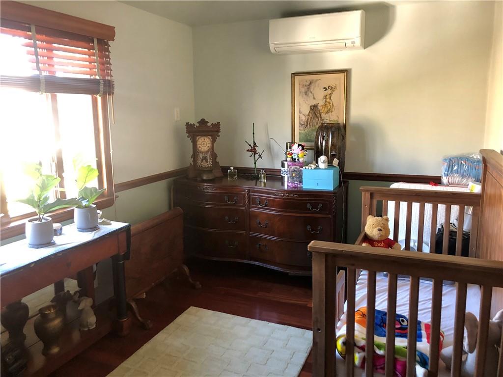 1933 Hendrickson Street Brooklyn, NY 11234 - Photo 14 of 17 a room with a wooden floor and a dresser