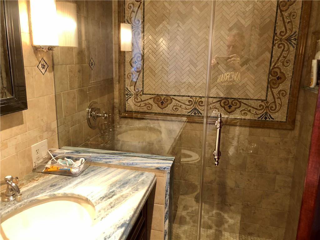1933 Hendrickson Street Brooklyn, NY 11234 - Photo 16 of 17 a bathroom with a granite countertop shower sink and vanity