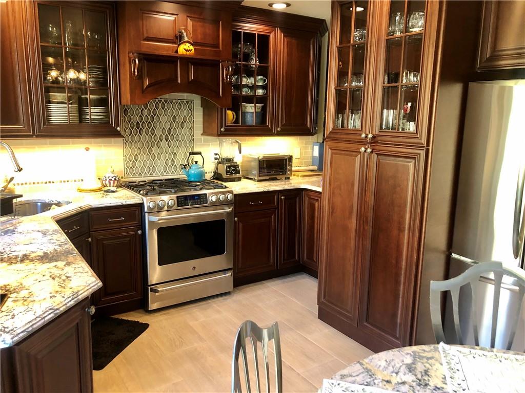 1933 Hendrickson Street Brooklyn, NY 11234 - Photo 5 of 17 a kitchen with stainless steel appliances granite countertop a stove and a refrigerator