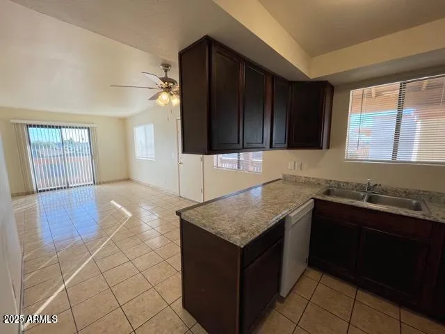 a kitchen with a sink a stove and cabinets