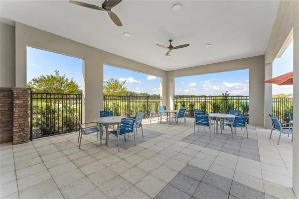 a view of a patio with a table and chairs under an umbrella