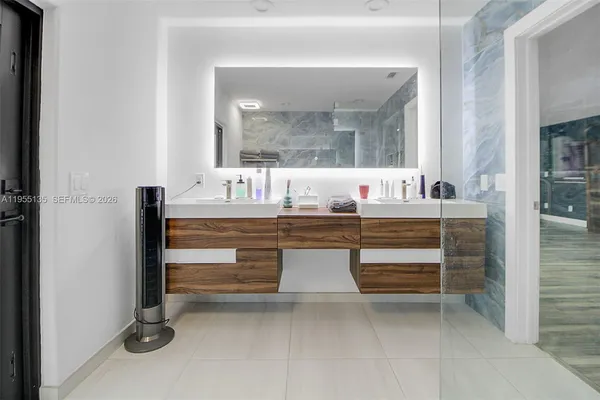 a kitchen with stainless steel appliances kitchen island granite countertop a refrigerator and a stove top oven