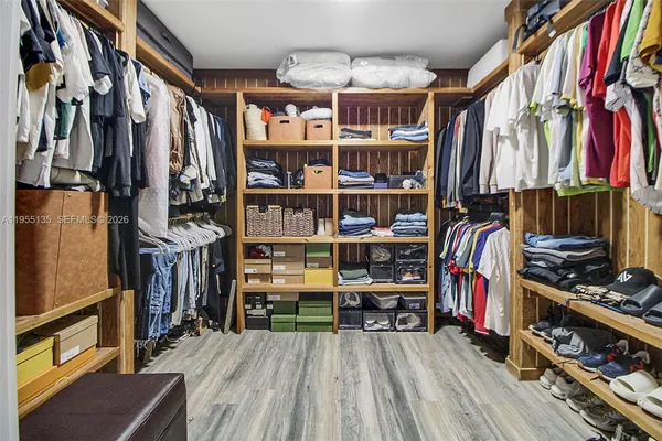 a view of a room with shelves and wooden floor