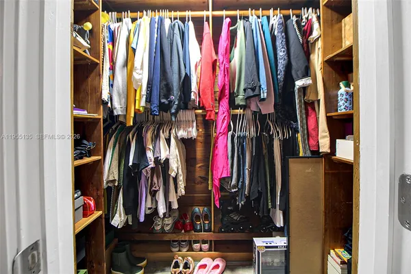 a view of a backyard with a tub and wooden fence