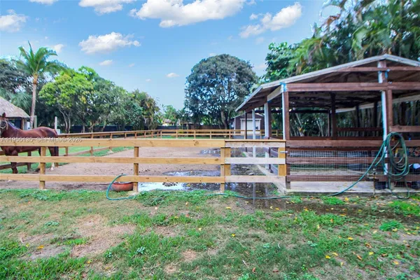 an aerial view of a house with yard swimming pool and outdoor seating