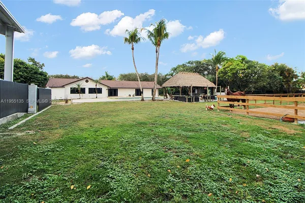 an aerial view of house with yard and outdoor seating