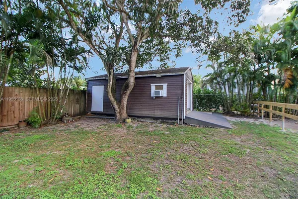 an aerial view of a house with a yard basket ball court and outdoor seating