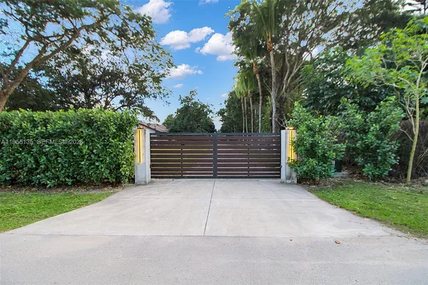an aerial view of a house with yard swimming pool and outdoor seating