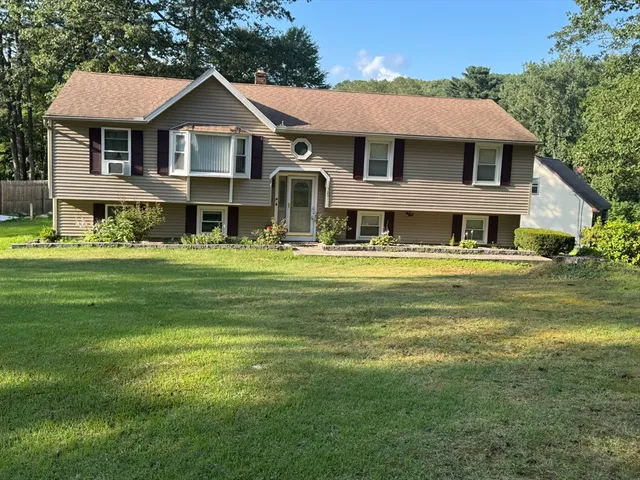 a front view of a house with a garden