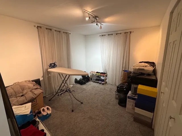 a bedroom with furniture and a chair