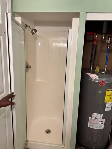 a bathroom with a shower and a mirror