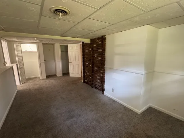 a view of an empty room with closet